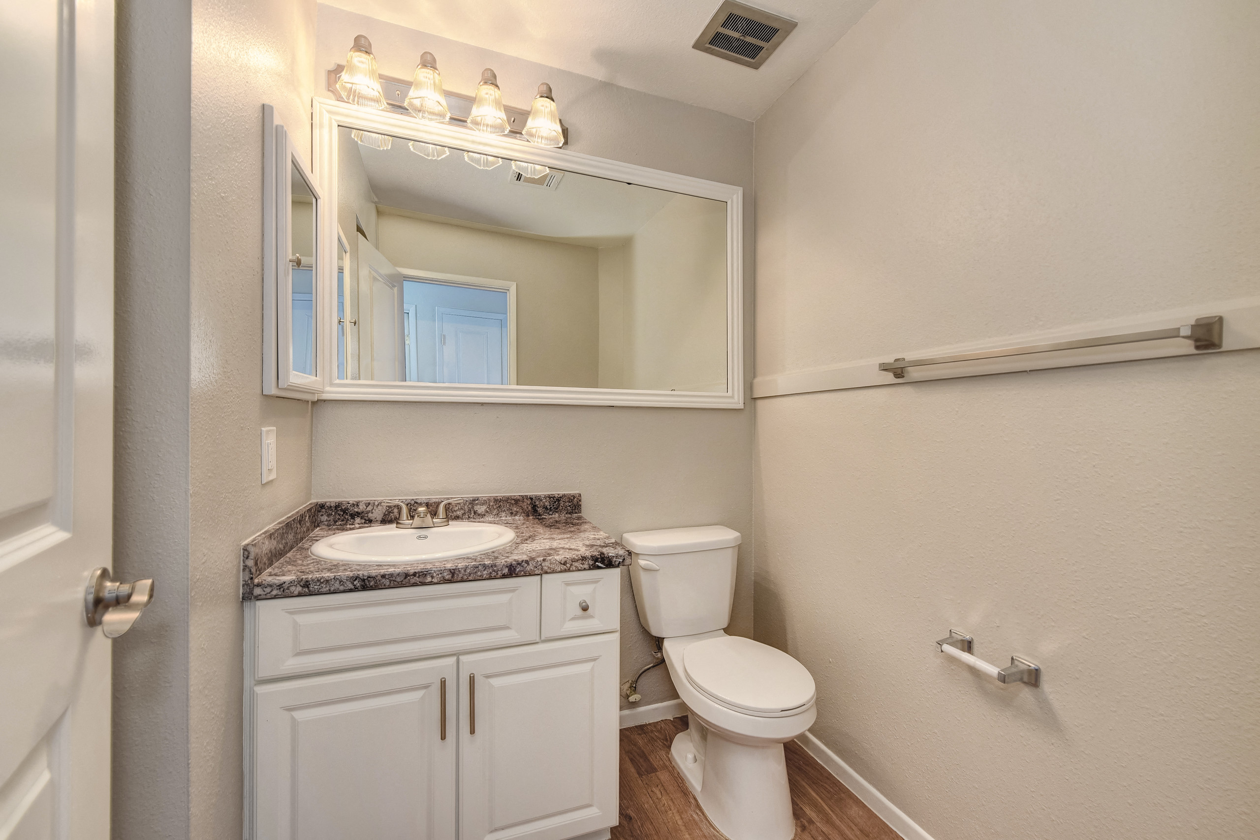 Two Bedroom Bathroom #1, white cabinetry and large mirror