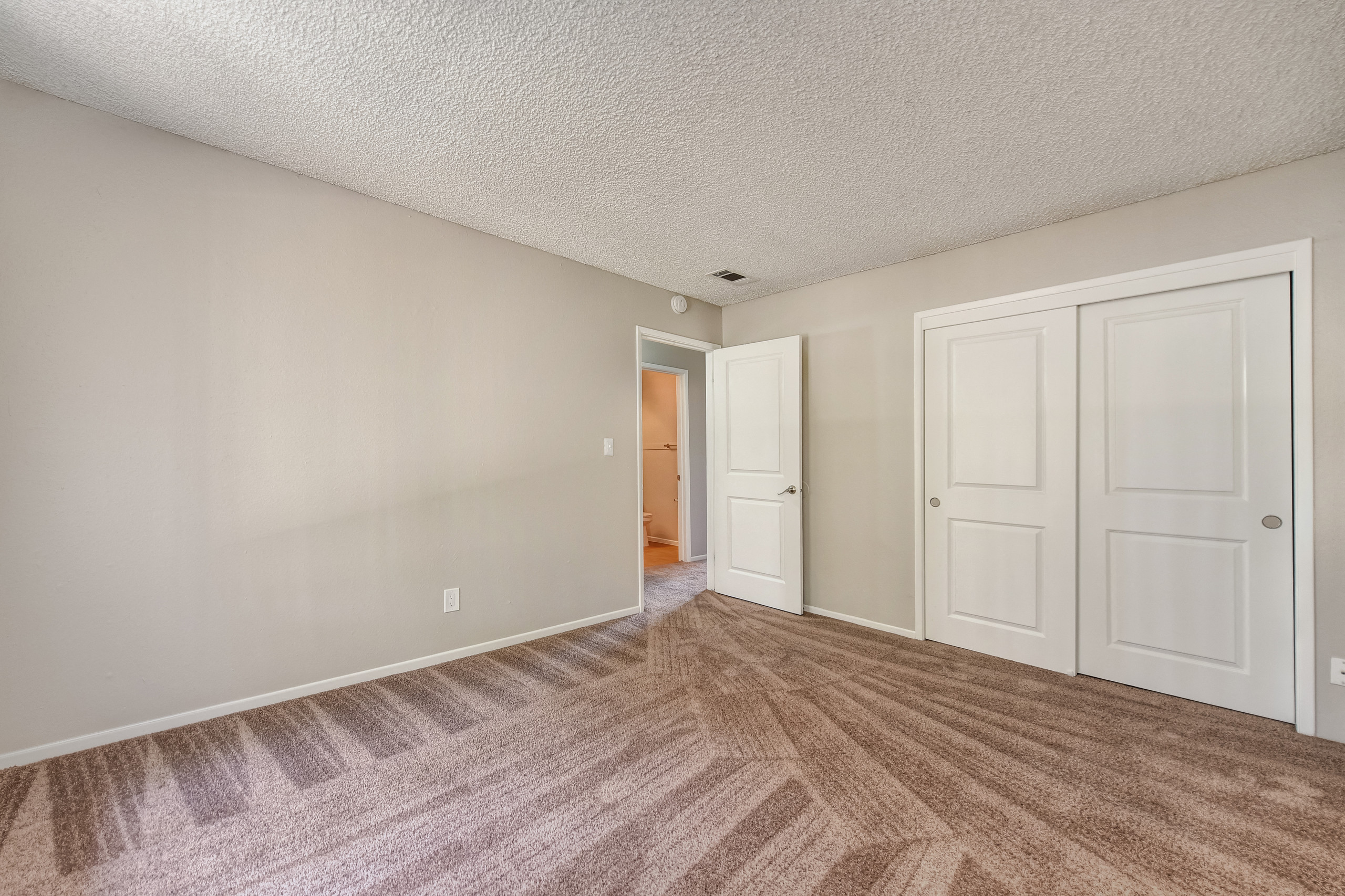 Bedroom 1 with large closets and wall to wall carpet