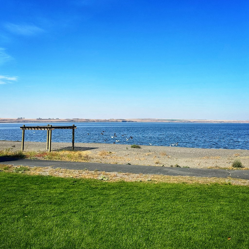 a picnic table on the beach near the water