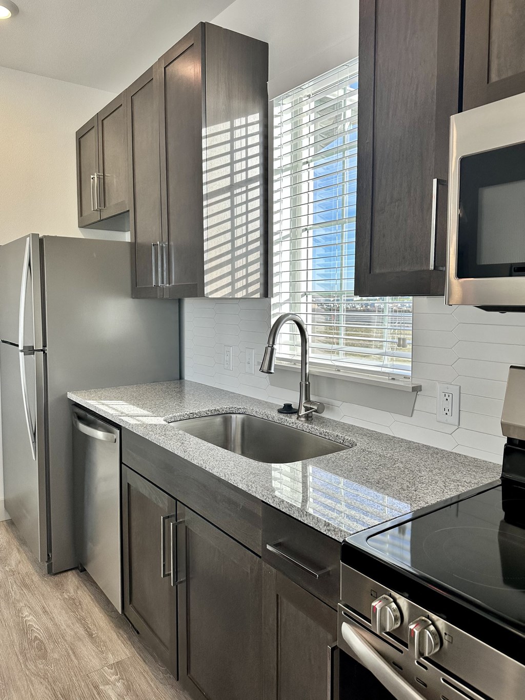 a kitchen with stainless steel appliances and a granite counter top