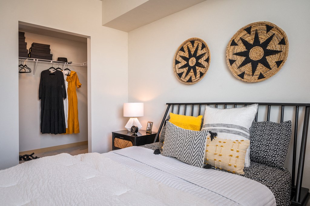 One Bedroom Apartments in Everett WA - The Waterline - Bedroom with Vinyl Hardwood Flooring, Area Rug, Stylish Decor, and Sliding Doors to the Balcony