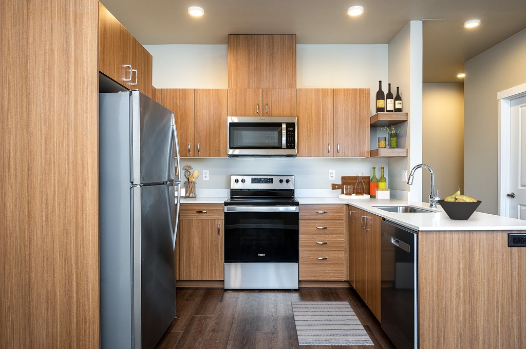 a kitchen with wooden cabinets and stainless steel appliances