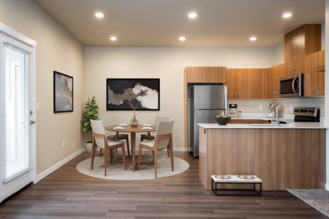 a kitchen and dining room with a table and chairs
