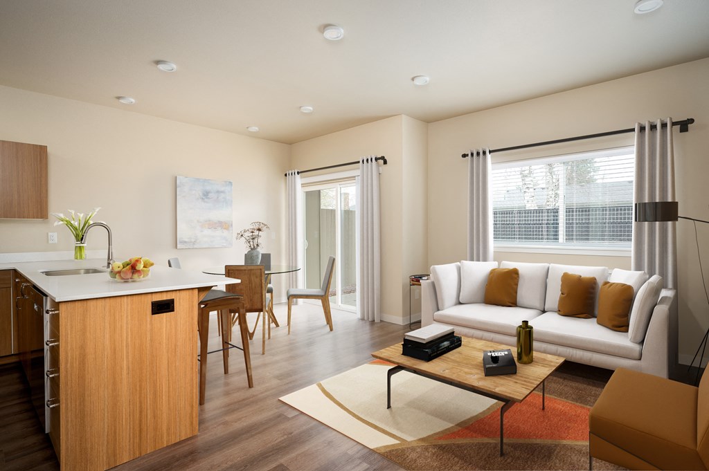 a living room and kitchen with a couch and a table