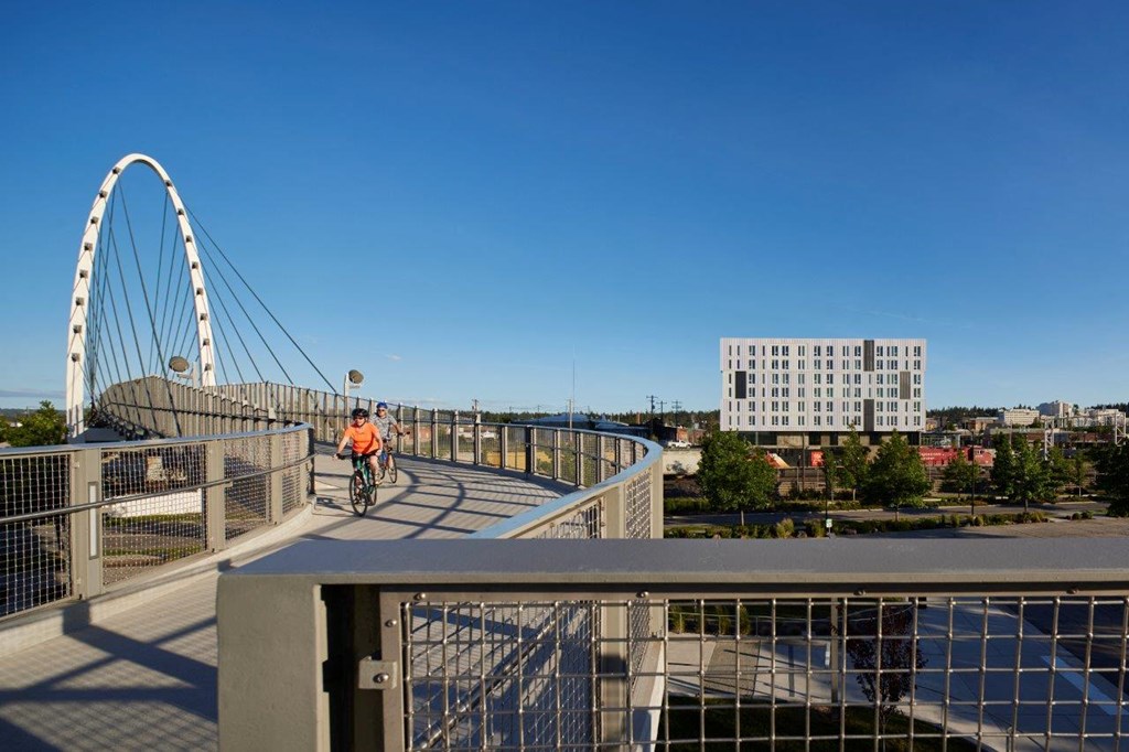 a man riding a bike across a bridge