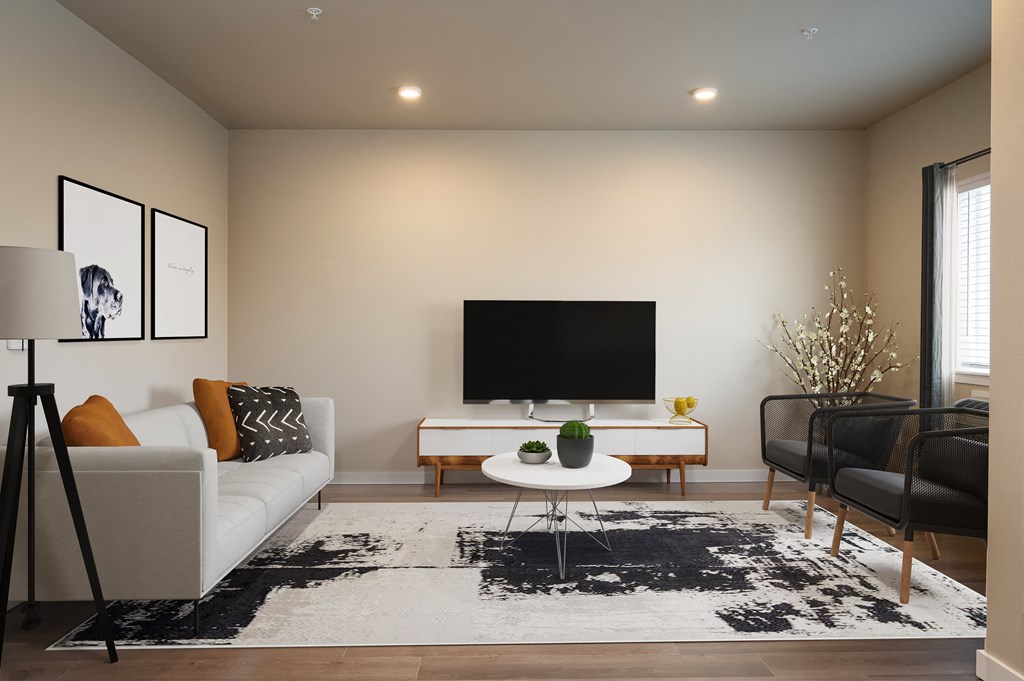 a living room with a white couch and a television