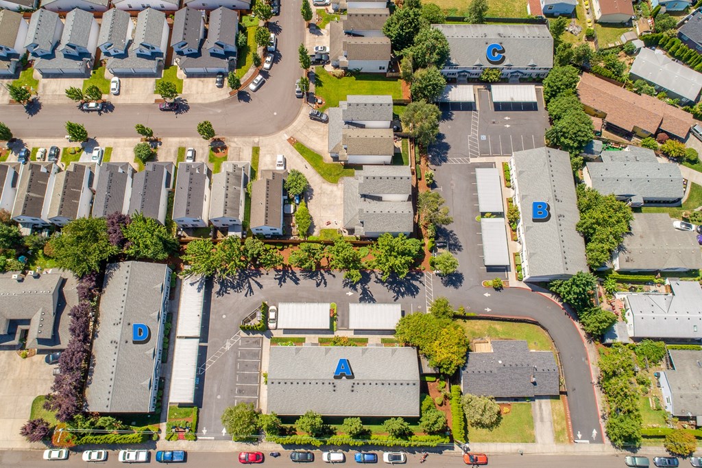an aerial view of a neighborhood of houses with cars parked