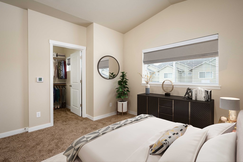 a bedroom with a large bed and a window