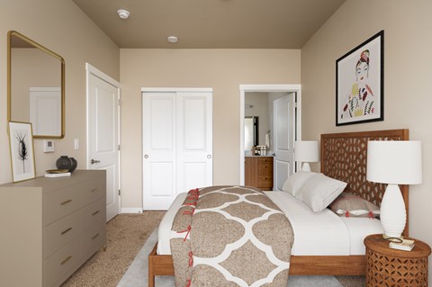 a bedroom with a bed and a dresser and a mirror