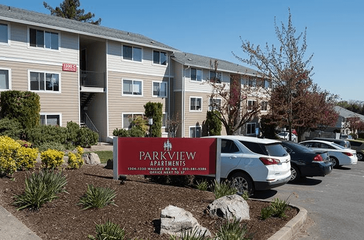 a parkview apartments sign in front of a building