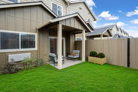 a covered patio in front of a house