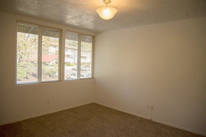 an empty living room with a large window