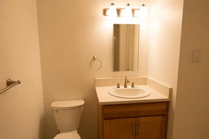 a small bathroom with a sink toilet and mirror