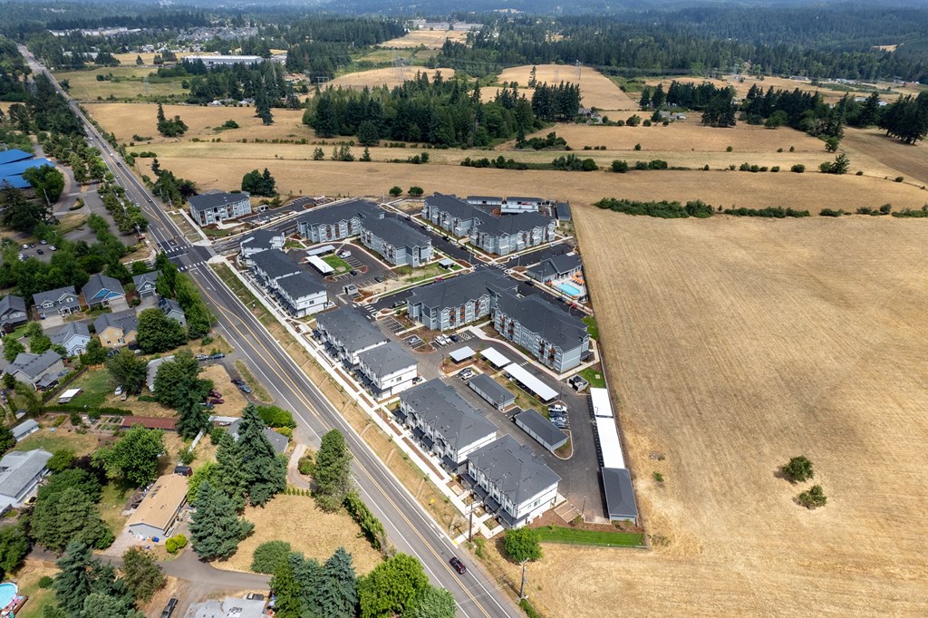 an aerial view of a large commercial building with a highway in front of it