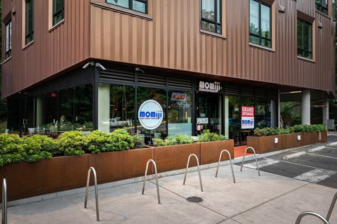 a sidewalk in front of a building with a noon sign