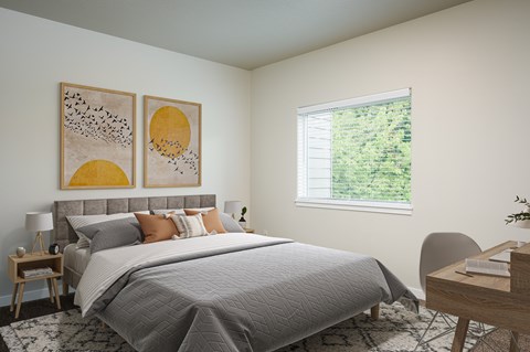 A bedroom with a large bed and two yellow paintings on the wall.
