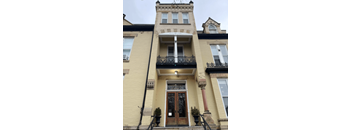 a building with a door and a light on the side of it