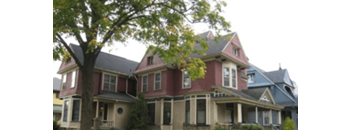 a large house with a large tree in front of it