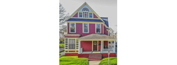 a red house with yellow trim and a blue roof