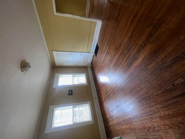 a view from the top of the stairs looking down into the hallway