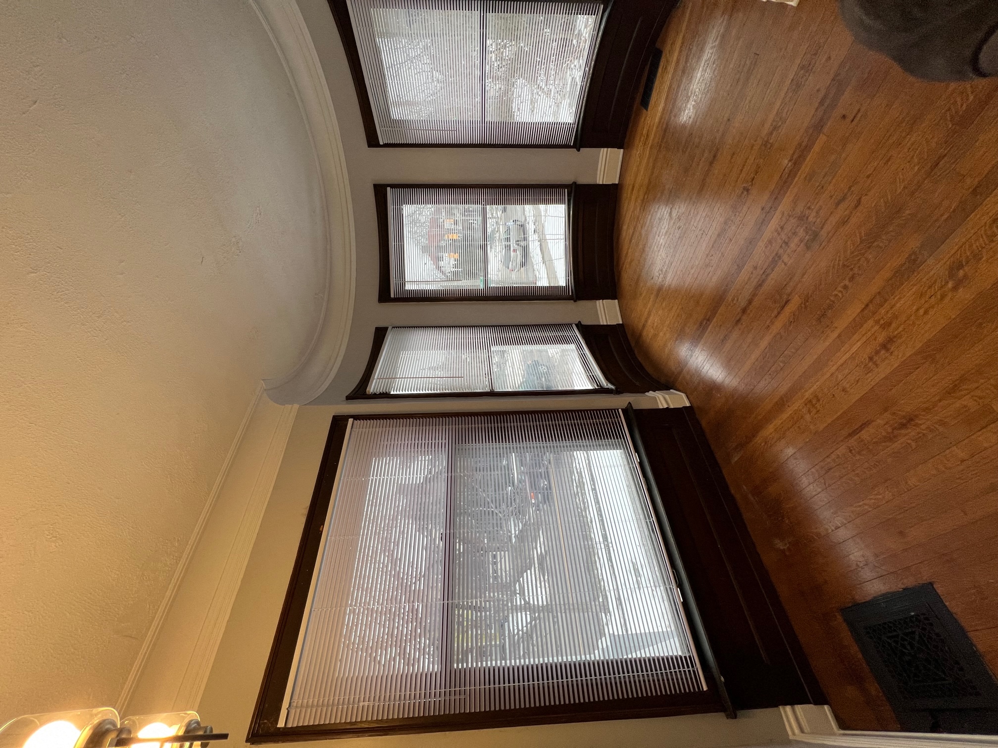 a view from the bottom of the stairs looking up at the windows in the stairwell