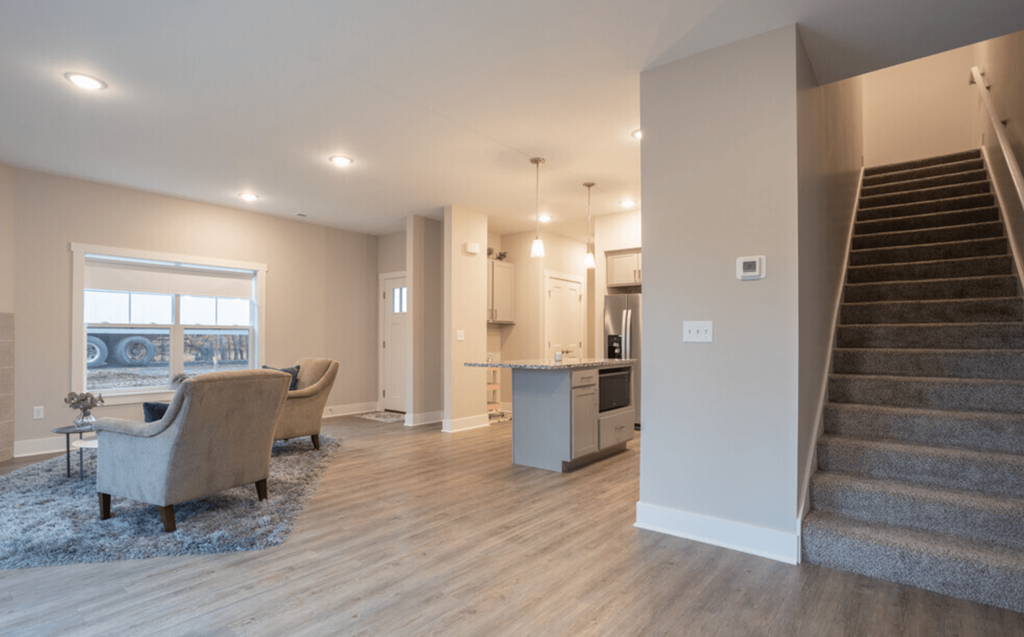 A living room with a staircase leading to the upper floor.
