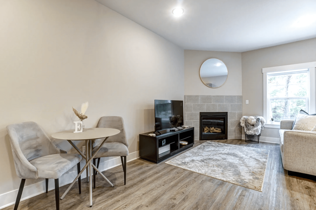 A living room with a fireplace and a television.