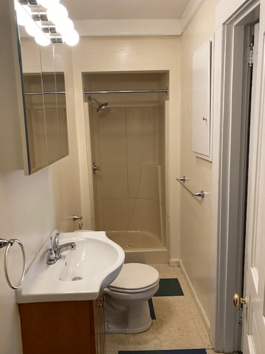 a small bathroom with a sink toilet and shower