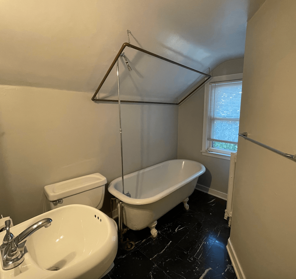 a bathroom with a sink toilet and a bath tub