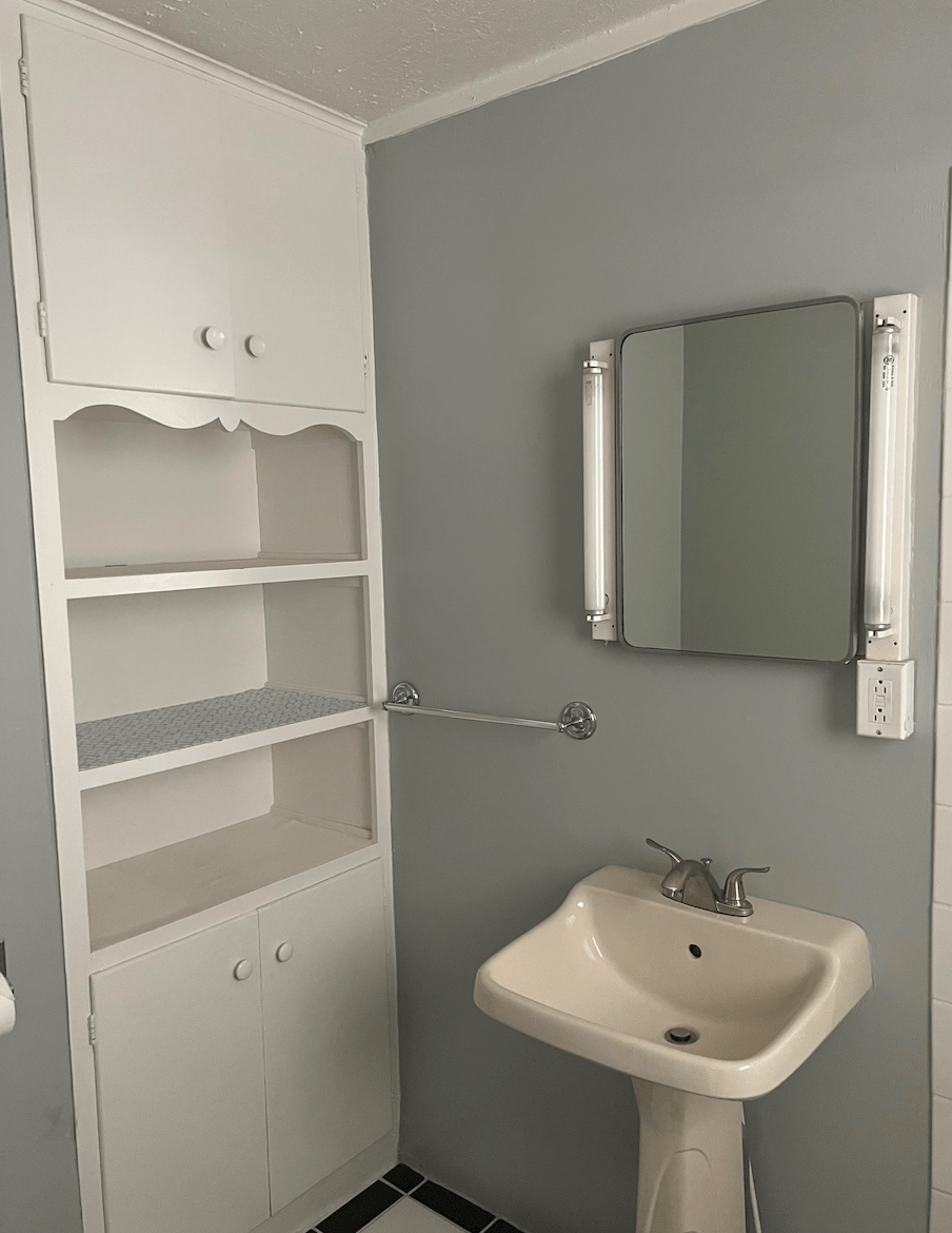 a small bathroom with a sink and a mirror
