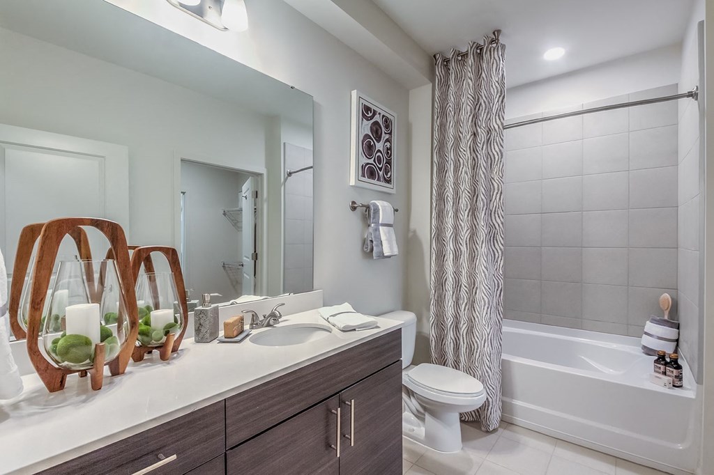 A bathroom with a white sink, toilet, and bathtub at Crabtree Lakeside Apartments, Raleigh, North Carolina