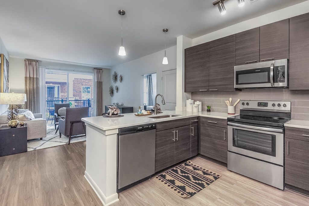 A modern kitchen with a large island and stainless steel appliances at Crabtree Lakeside Apartments, Raleigh, 27612