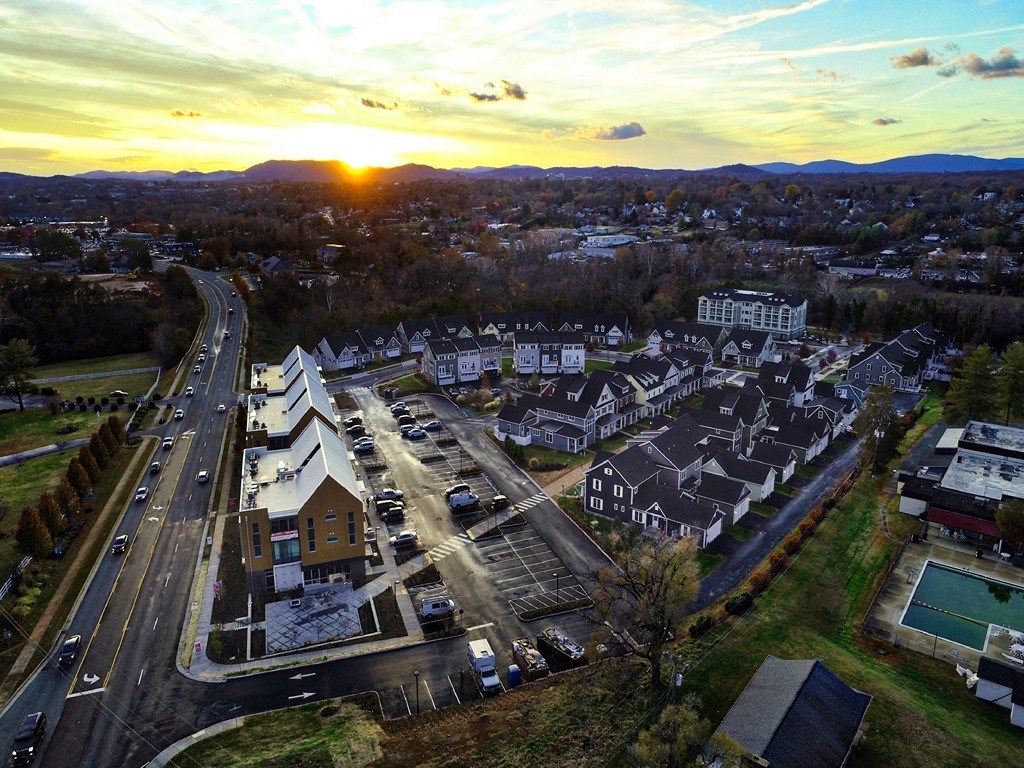 a sunset over a city with cars on the road