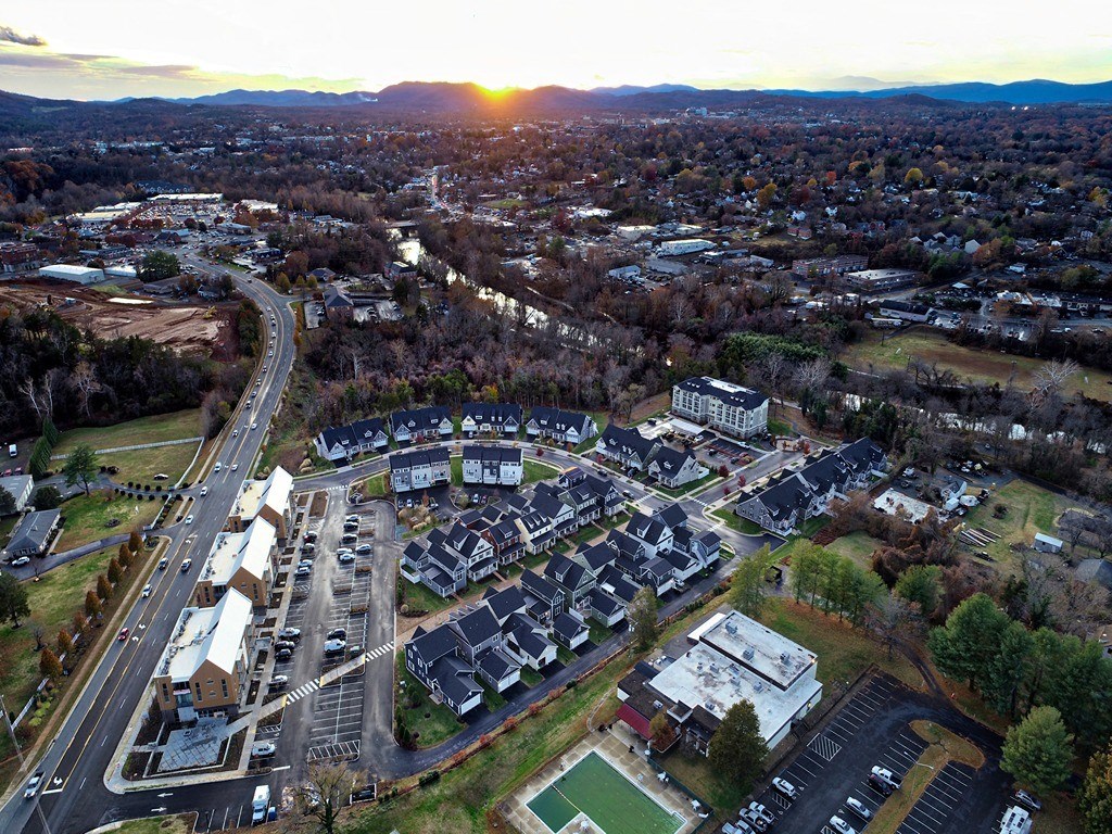 an aerial view of a city at sunset