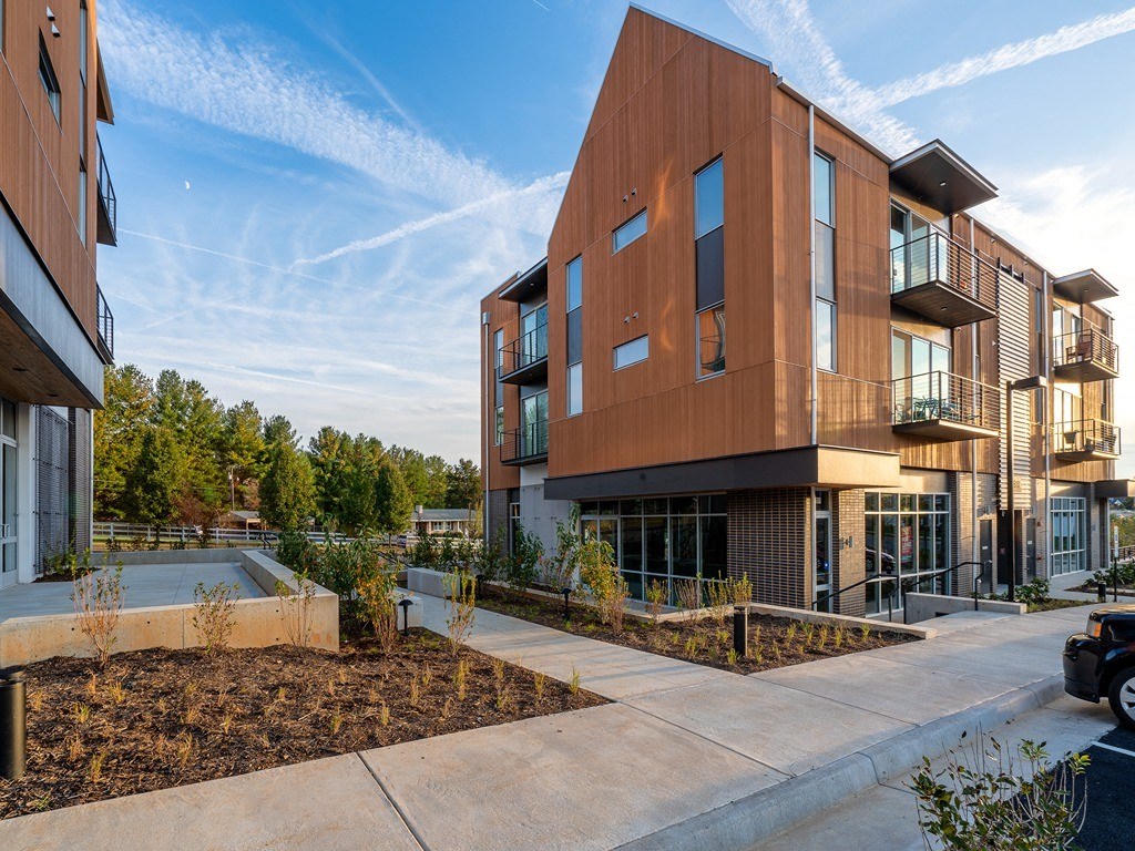 a view of a building with a pool in front of it