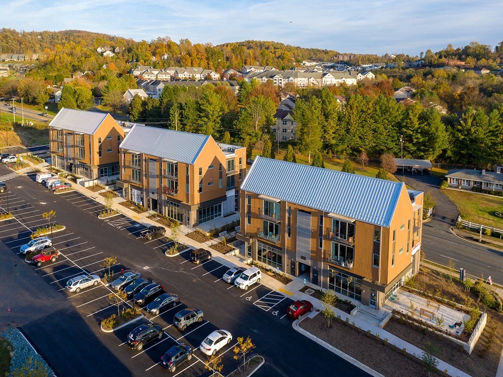 an aerial view of apartment buildings and a parking lot
