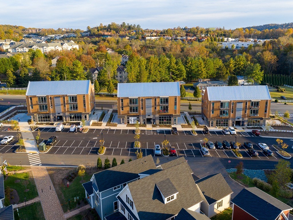 an aerial view of a building with a parking lot