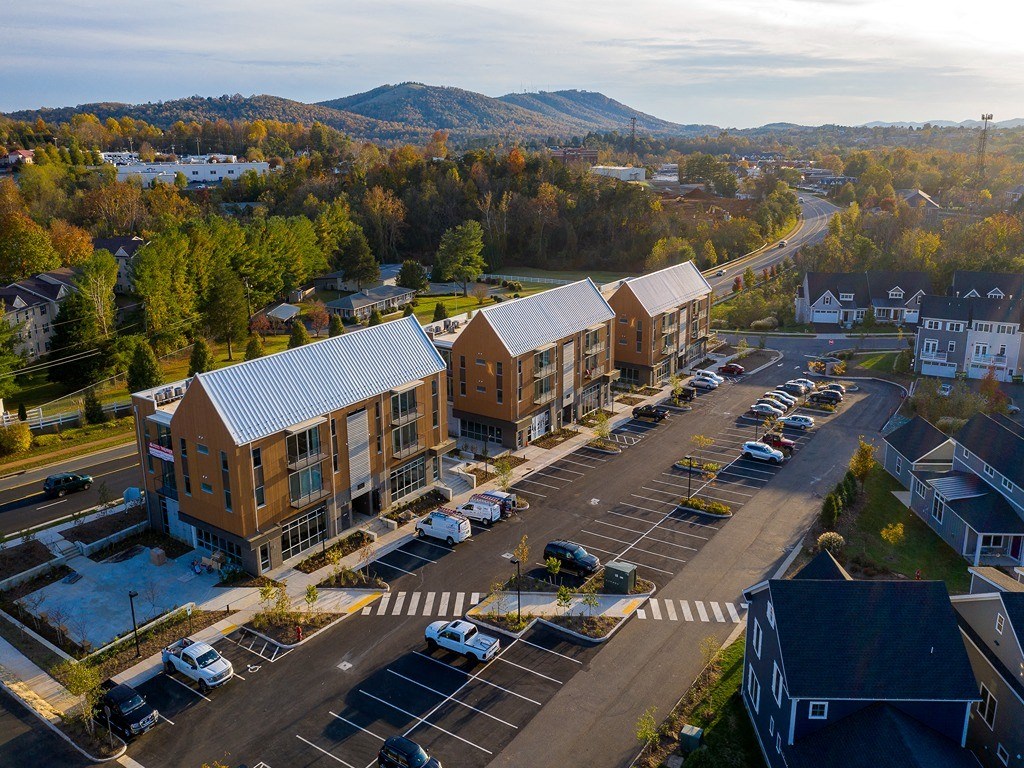 an aerial view of apartment buildings on a city street