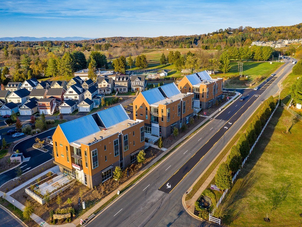 an aerial view of a group of buildings with blue roofs