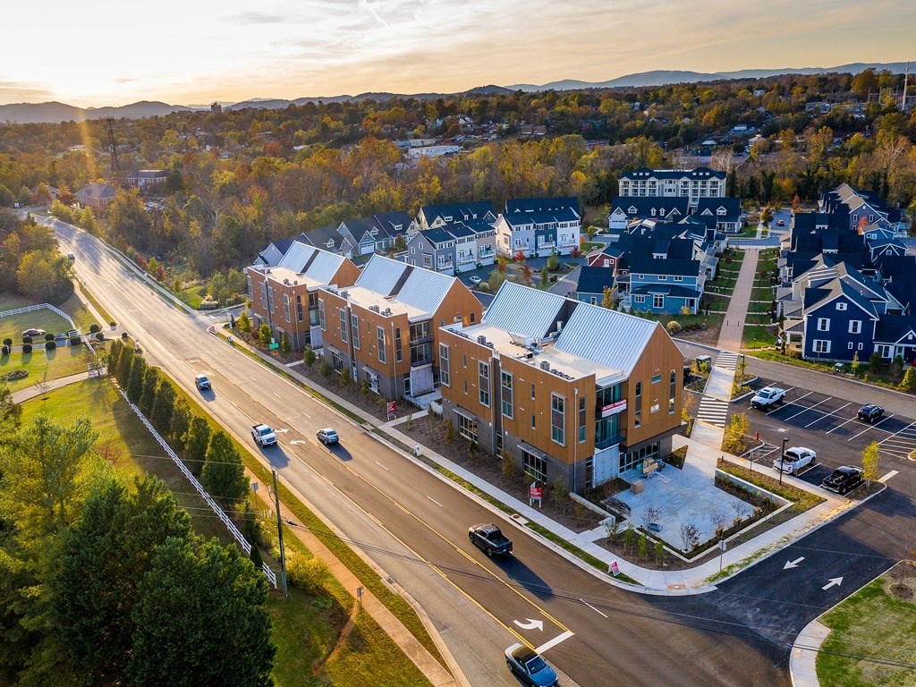 an aerial view of an apartment building on a city street