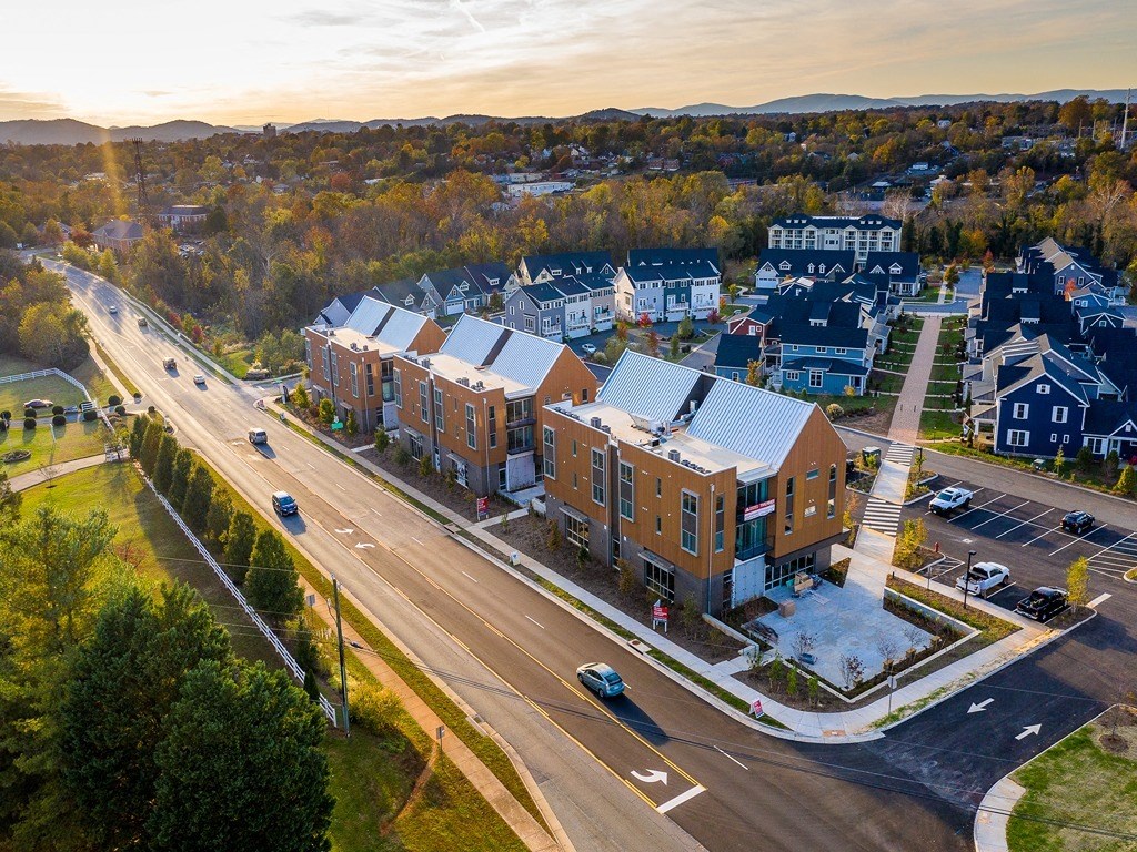 an aerial view of an apartment building on a city street