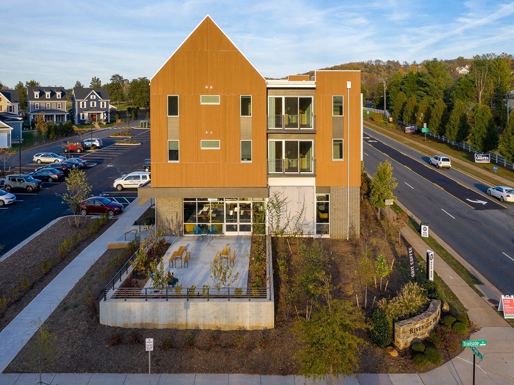 an aerial view of a building with a city street in the background