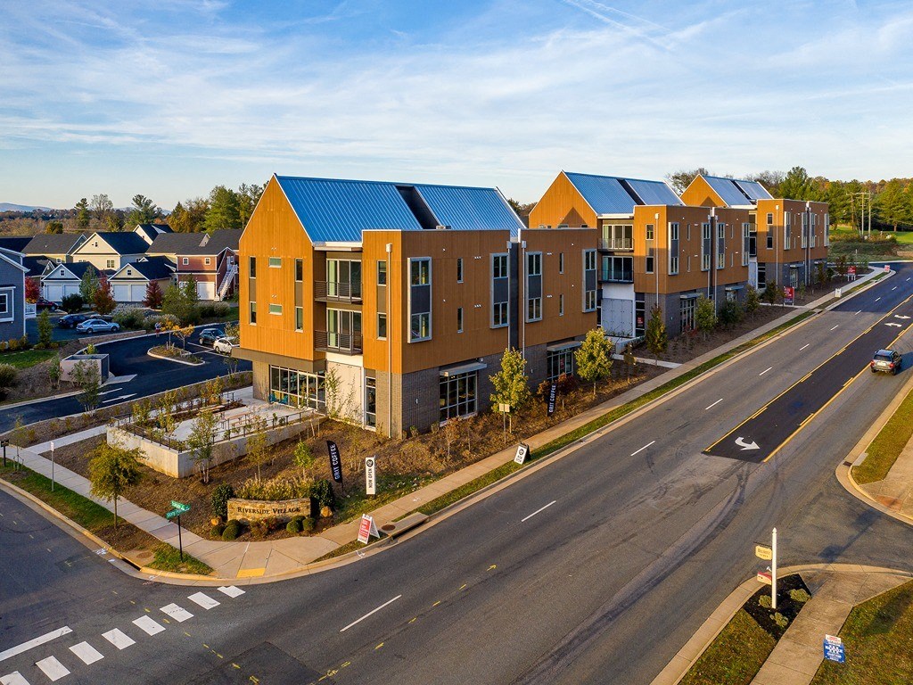 a building with a blue roof and a street in front of it