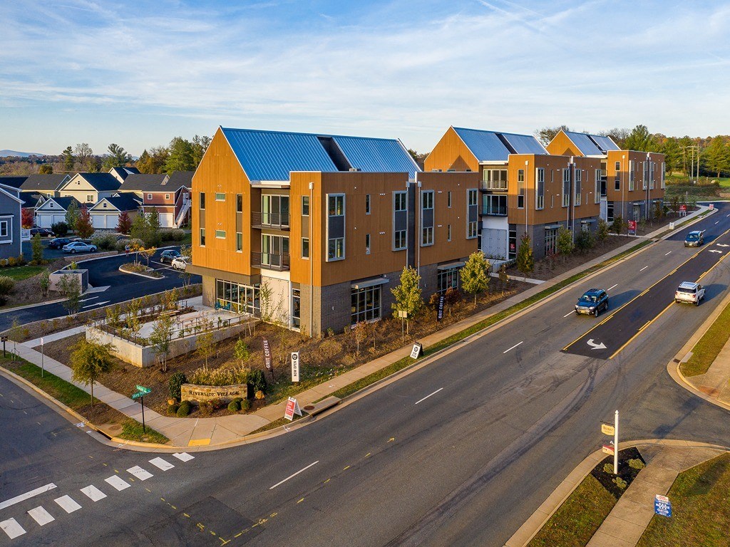 a building with a blue roof and a street in front of it