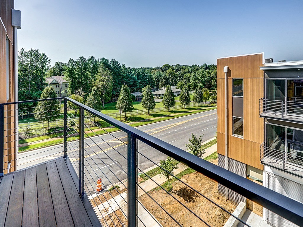 a view from the balcony of a building with trees in the background