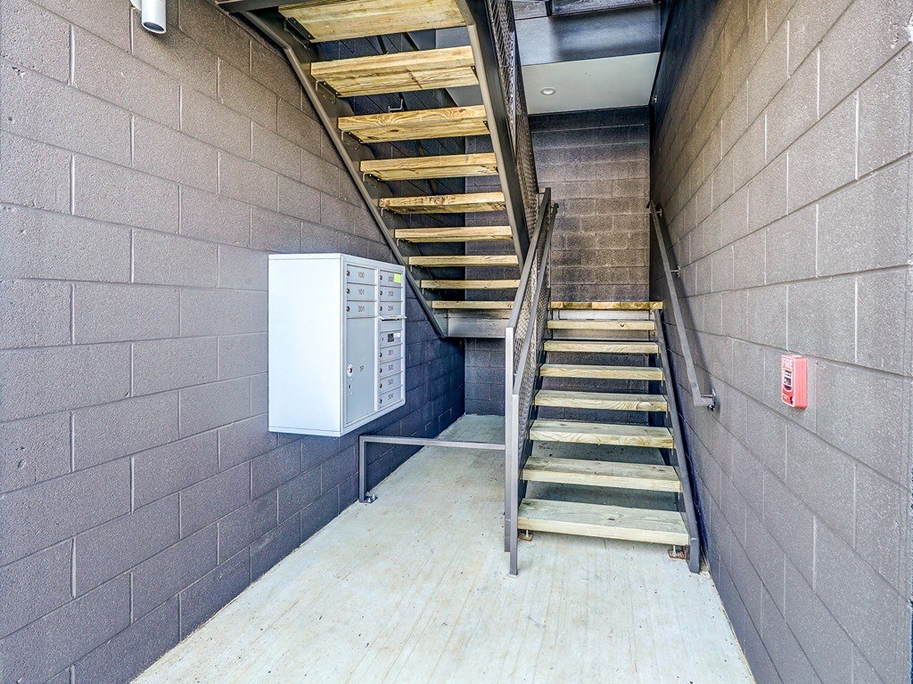 a set of stairs next to a brick wall with a modem on the side