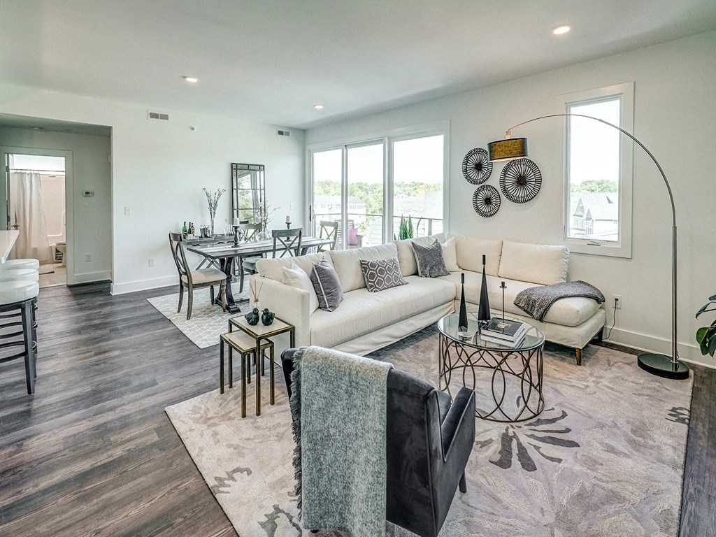a living room and dining room with a couch and a table