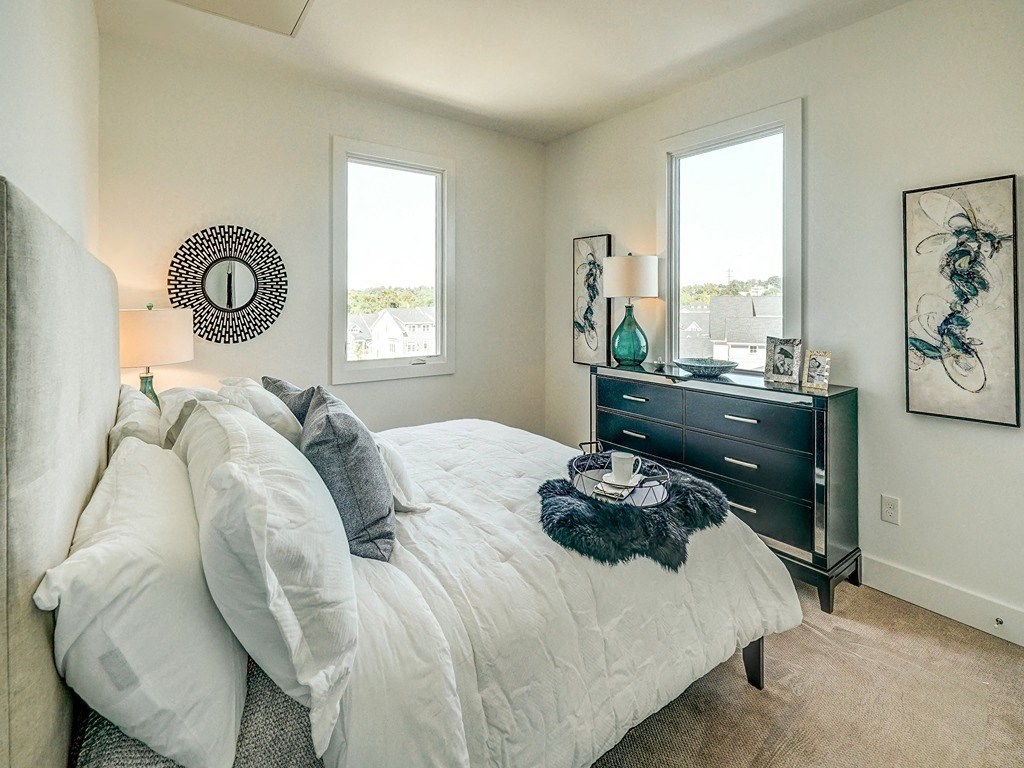 a bedroom with a bed and a dresser