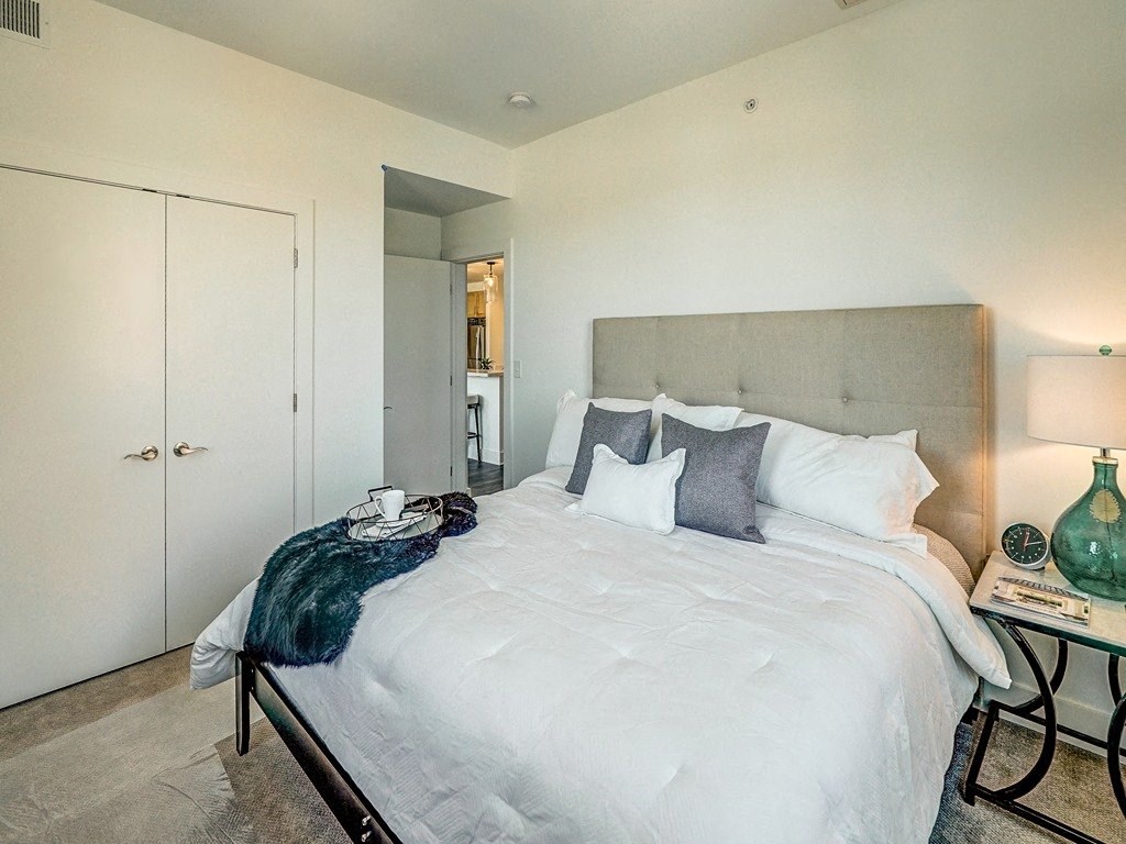 a bedroom with a large bed and a closet