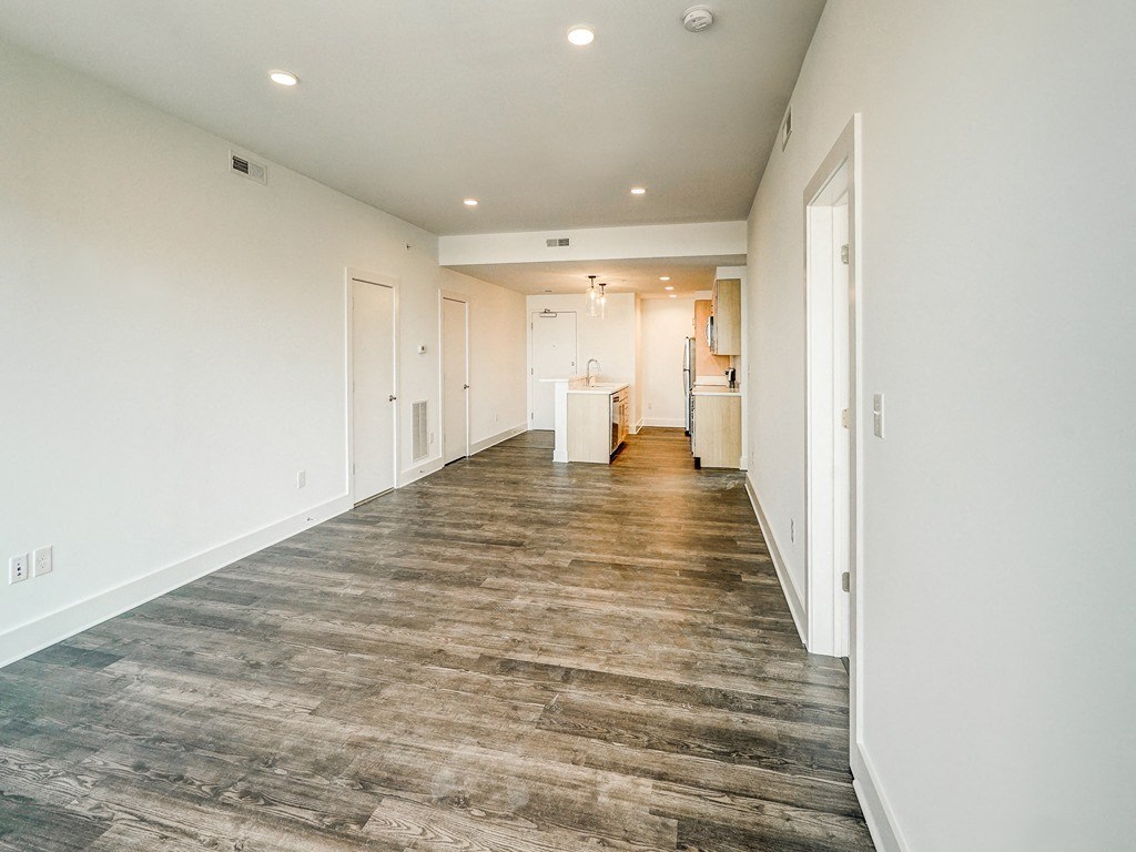 a long hallway with white walls and white doors